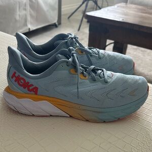 Hoka Pale Blue Running Shoes with Yellow and Red Accents